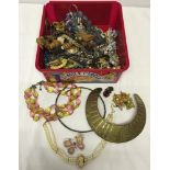 A large plastic box of vintage and modern costume jewellery including diamante earrings and