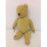 A late 1940s / early 1950s teddy bear. Sheepskin fur, stitched nose and mouth. Missing eyes - called