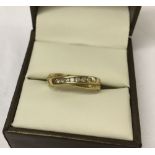 Ladies 9ct gold dress ring with cross over design set with 7 diamonds. Size O.
