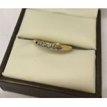 18ct gold ladies ring set with 5 small diamonds. Size N«.