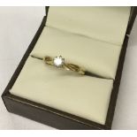 Ladies 9ct gold ring set with a 0.2ct solitaire white stone.