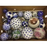 A box containing approx 27 ornamental ceramic balls of different sizes and designs.
