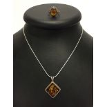 A 925 silver ring with faux amber cabouchon, size O, together with a silver pendant necklace set