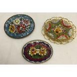 3 micro mosaic brooches in oval mounts with flower designs.