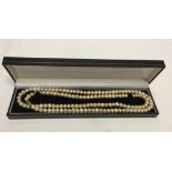 A string of freshwater pearls measuring approx 32" long with an ivory sheen. Has barrel screw