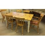 A pine kitchen table with cream painted legs and 6 chairs (2 carvers). Table top 153 x 89cm.