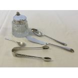 A small collection of silver items comprising silver lidded mustard pot and spoon, sugar tongs,