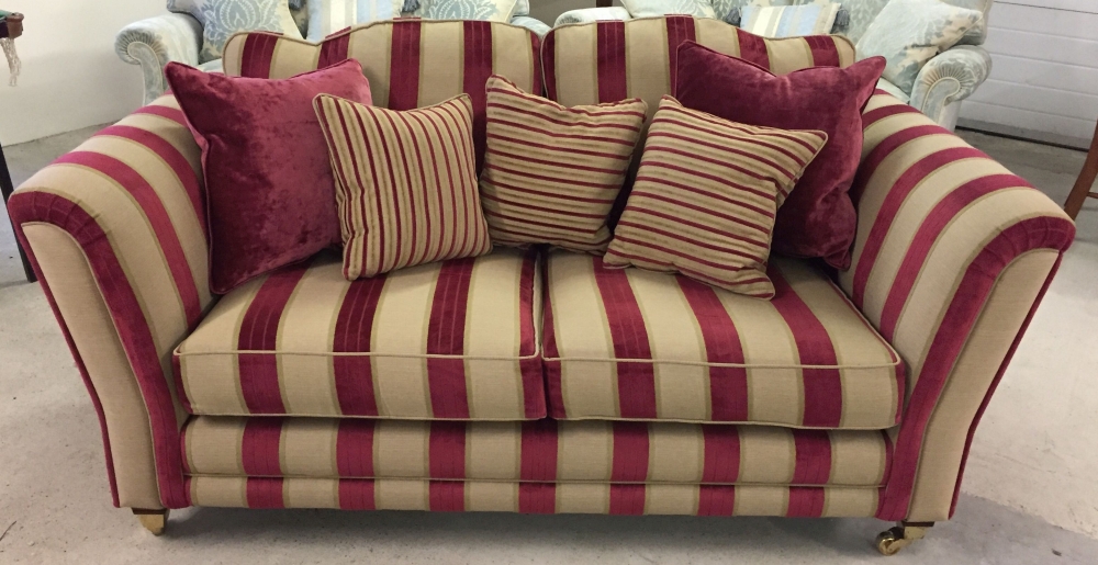 A reproduction Victorian 2 seater sofa in red & gold striped upholstery with wooden and brass