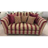 A reproduction Victorian 2 seater sofa in red & gold striped upholstery with wooden and brass