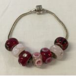 A Rhona Sutton silver bracelet and 7 Rhona Sutton Murano glass beads with 925 silver cores - red &