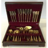 A wooden canteen of brass cutlery.