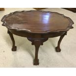 An oval pie crust top coffee table with ball & claw feet. Top 65 x 48cm.