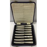 A cased set of 8 silver butter knives with mother of pearls handles