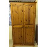 A pine wardrobe 187cm tall, 97cm wide & 59cm deep.