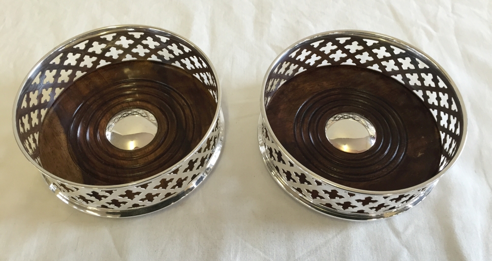 A pair of silver plated coasters.