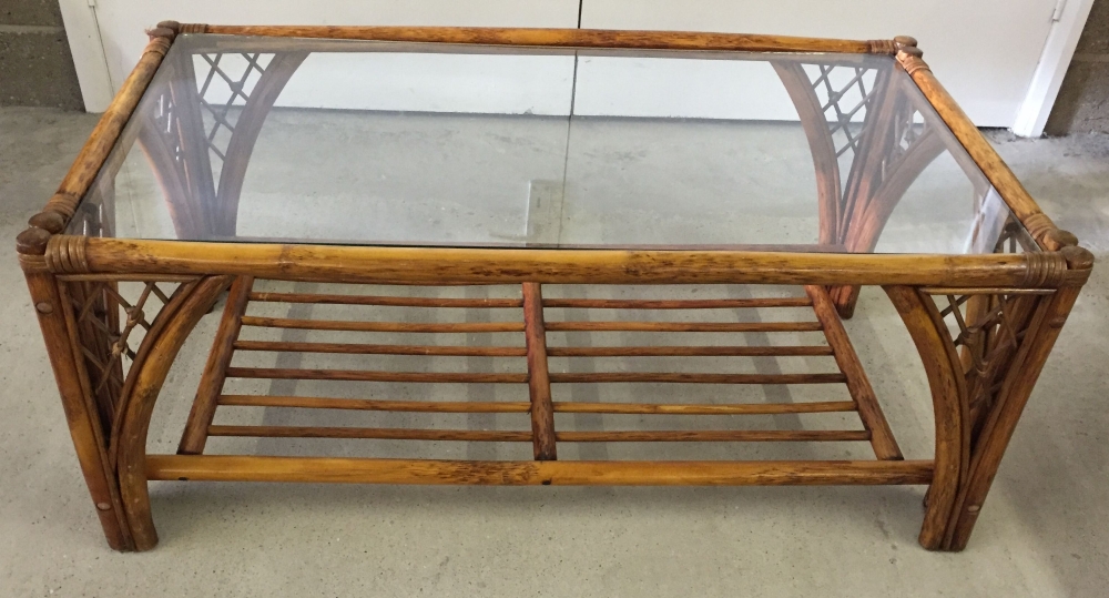 A glass topped bamboo coffee table.