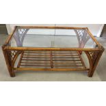 A glass topped bamboo coffee table.