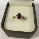 Hallmarked 9ct gold dress ring set with an oval garnet. Size approx M1/2, total weight approx 1.9g