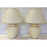A pair of large cream & gold table lamps with cream & gold shades.