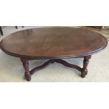 An oval block wood top coffee table. 122 x 71cm.