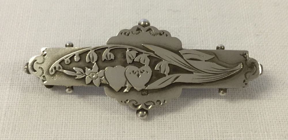 Silver bar brooch with Lily of the Valley design in an Art Nouveau style. Approx 4cm wide.