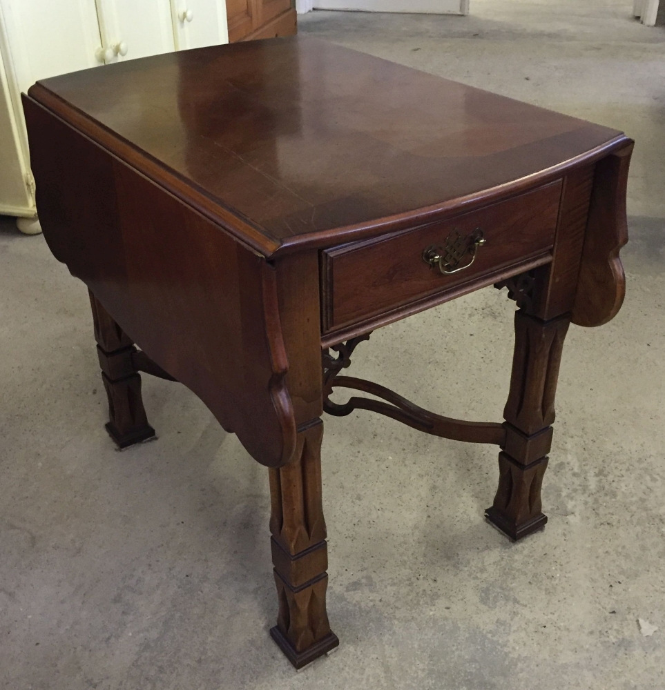 A mahogany drop leaf coffee table with fretwork stretcher and square carved legs. Size when