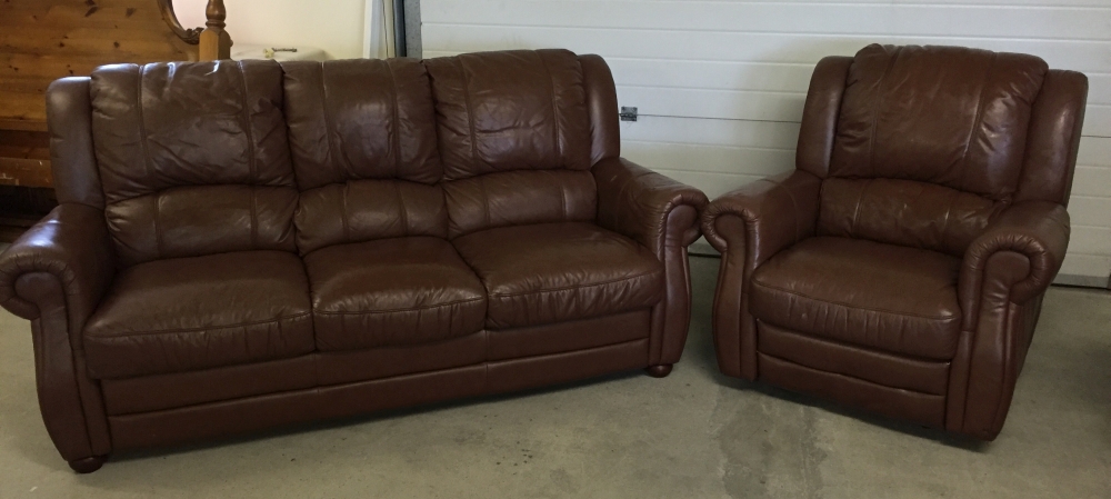 A large 3 seater brown leather settee and matching reclining armchair.