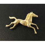 Hallmarked 9ct gold prancing horse brooch. Approx 3.25cm x 2.5cm. Weight approx 2.7g