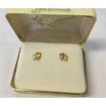 An American Landstrom's Black Hills 10K gold leaf design pair of earrings with 3 spare backs.