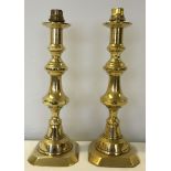 A pair of brass candlesticks converted to table lamps.