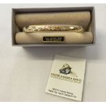 An American South Dakota Black Hills gold bangle. Bangle gold plated marked 14K G F set with 12K