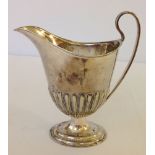 An un-hallmarked white metal milk jug, approx 116g.