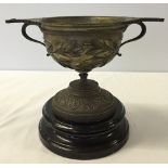 A heavy early 20th century/late 19th century brass chalice on ceramic box.