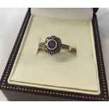 Flower design ring set with central amethyst and marcasites. 925 silver. Size P.