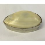 White metal Pill box with mother of pearl top. Scratched '800' to base possibly continental silver