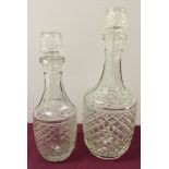 2 graduated sized glass decanters.