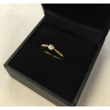 An 18K gold diamond solitaire ring. Size K½. Approx 1.9g.