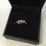 An 18K gold diamond trilogy ring. Size N. Approx 2.9g.