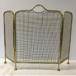 A vintage brass fire guard.