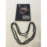 A boxed 48 inch haematite necklace with a Guide to Gemd & Jewellery book.