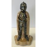 An enamelled metal companion set holder in the shape of a knight with tongs. 38cm tall.