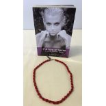 A boxed Red coral & silver 18 inch necklace with a 'Lure of Gems' book.