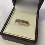 9ct gold dress ring set with five round Amethysts. Size M.