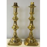 A pair of brass candlesticks converted to table lamps.