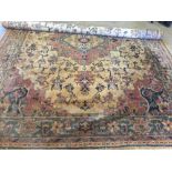 A very large gold patterned rug approx 340 x 270cm