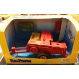 A boxed Ertl 1:32 scale Big Farm New Holland square baler with bales. Box missing celophane window.