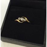 An 18K gold diamond trilogy ring. Size N. Approx 2.9g.