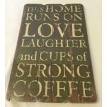 A modern motto sign 'This House Runs on Love' 45 x 30cm.