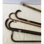 A collection of 6 walking sticks with silver tips/collars.