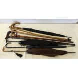 A collection of vintage umbrellas & walking sticks.